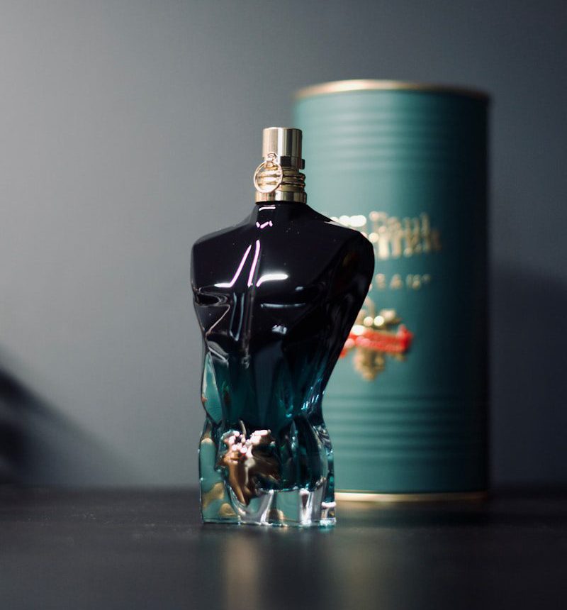 a bottle of perfume sitting next to a can